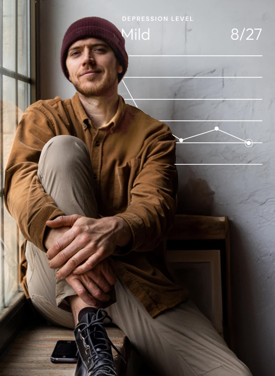 man sitting on the ground and smiling